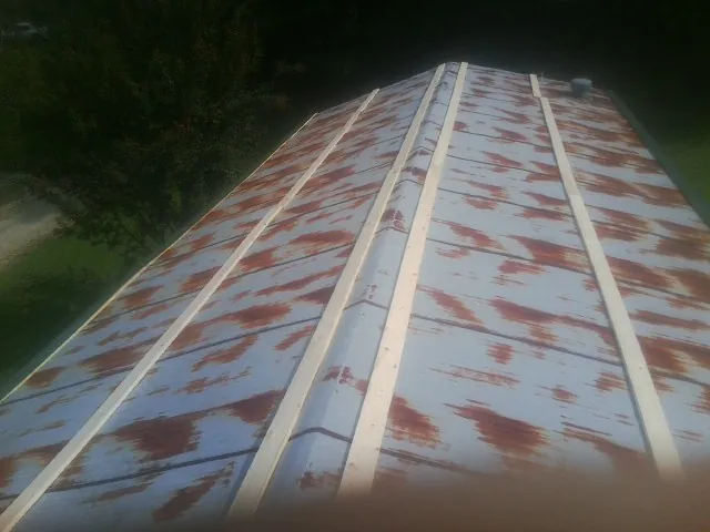 Rusted metal roof panels with new wood purlins before replacement — Storm Damage Roof Repair in Portola Valley by Roofing Brothers