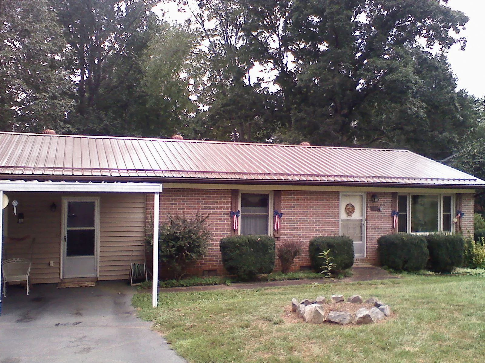 Bronze metal roof and carport on a brick ranch home — Roof Repair work by our crew in Portola Valley